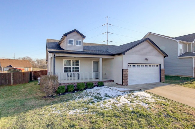 view of front of house featuring a front yard, covered porch, and a garage