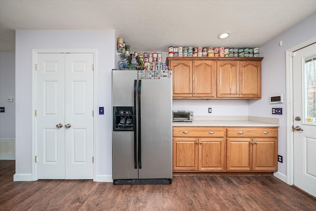 kitchen featuring a textured ceiling, dark hardwood / wood-style floors, and stainless steel refrigerator with ice dispenser