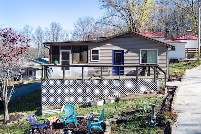 rear view of house with a sunroom