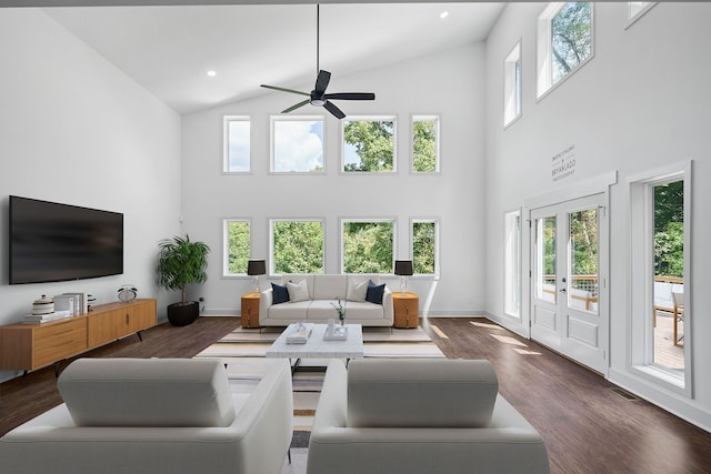 living room featuring ceiling fan, a healthy amount of sunlight, dark hardwood / wood-style flooring, and high vaulted ceiling