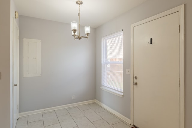 doorway to outside with electric panel and an inviting chandelier