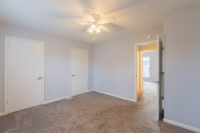 unfurnished room with carpet and ceiling fan