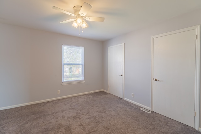 carpeted empty room with ceiling fan