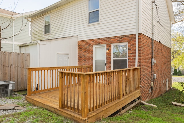 rear view of property with central air condition unit and a deck