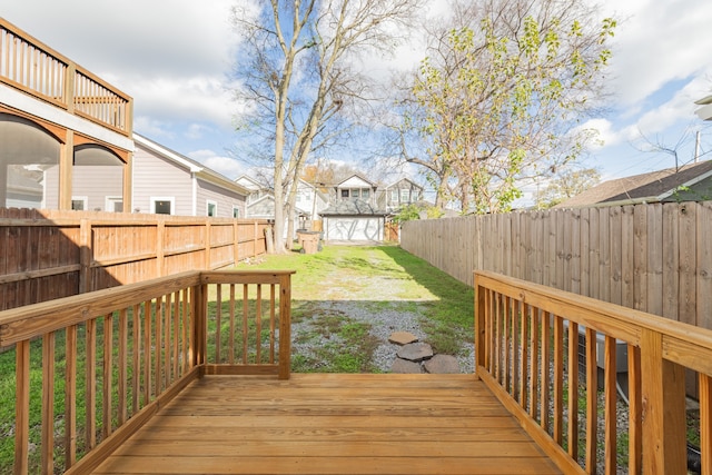 wooden deck featuring a yard and a storage shed