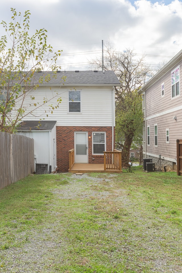 back of property featuring a yard and a wooden deck