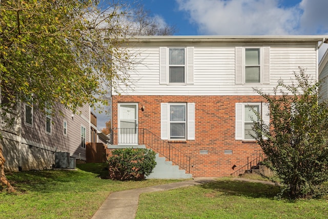 view of front of property featuring central AC unit and a front lawn