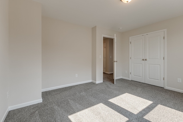 unfurnished bedroom featuring carpet and a closet