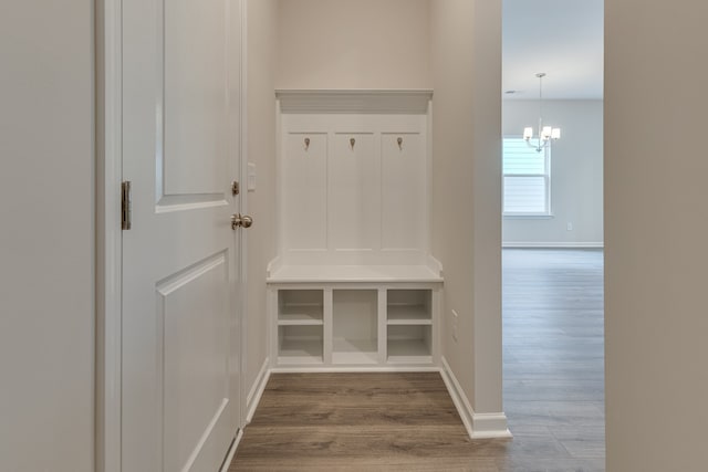 mudroom featuring hardwood / wood-style flooring and an inviting chandelier