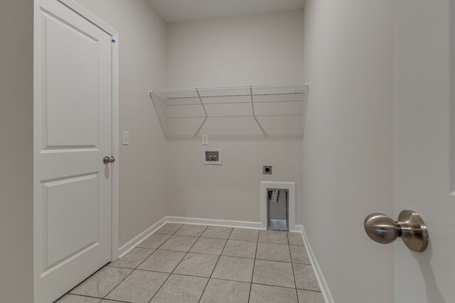 washroom featuring hookup for an electric dryer, hookup for a washing machine, and light tile patterned floors