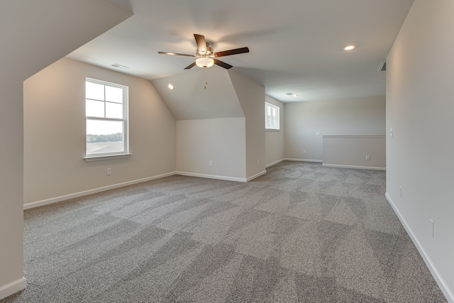 additional living space featuring ceiling fan, lofted ceiling, and light carpet