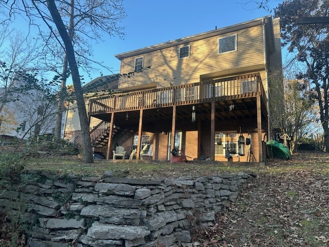 rear view of property featuring a wooden deck