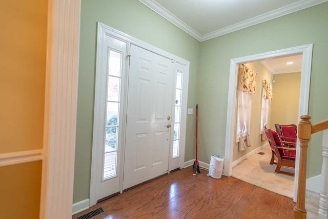 foyer entrance featuring ornamental molding and hardwood / wood-style flooring