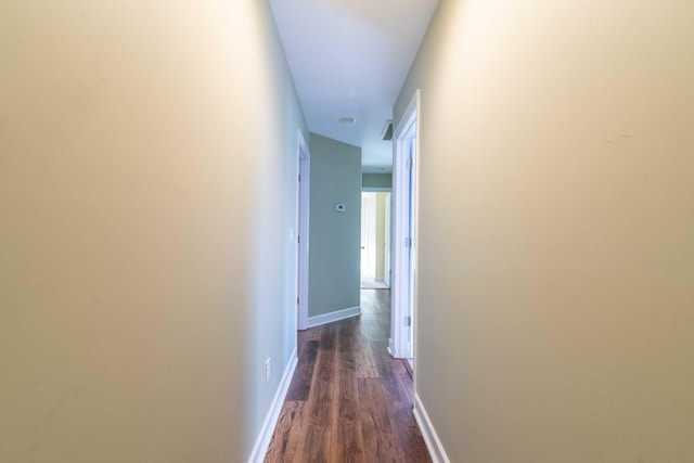 corridor with dark hardwood / wood-style flooring