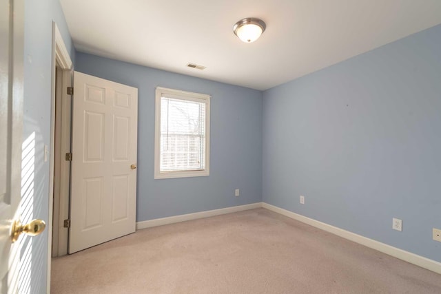 empty room with light colored carpet