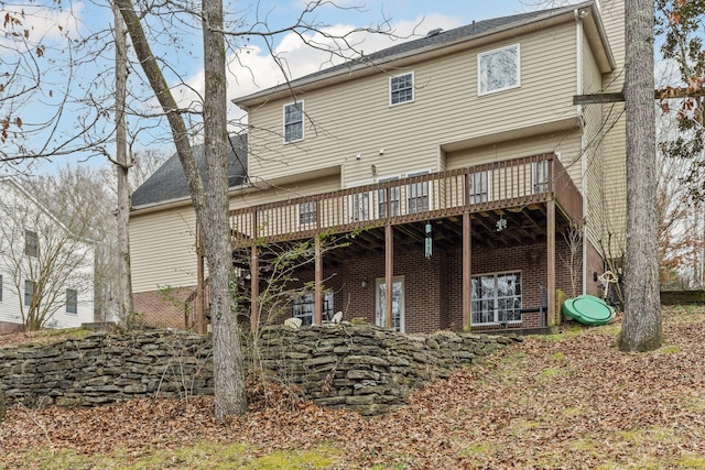 rear view of house featuring a wooden deck