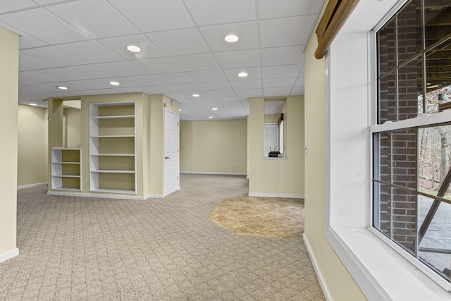 interior space featuring light carpet and built in shelves