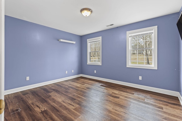 unfurnished room featuring dark hardwood / wood-style floors