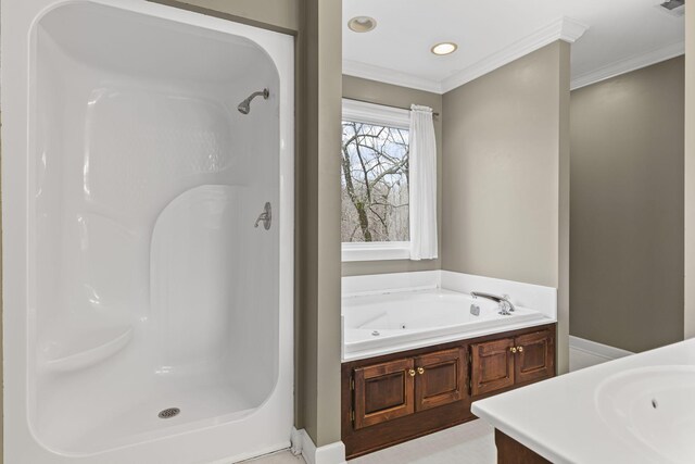 bathroom featuring crown molding, vanity, and a bathtub