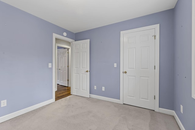 unfurnished bedroom featuring light colored carpet