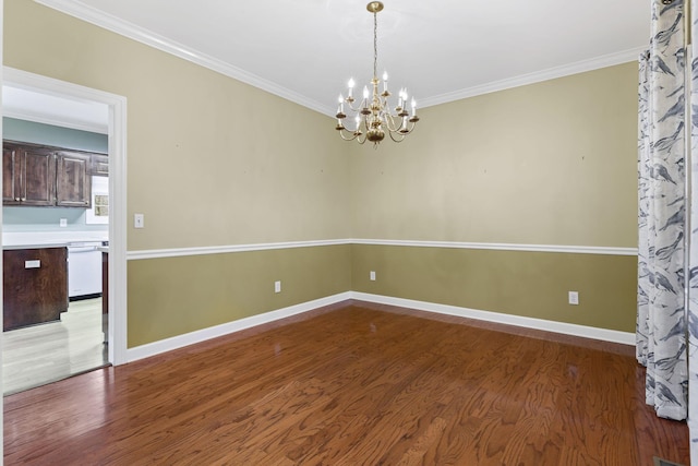 unfurnished room with crown molding, a notable chandelier, and hardwood / wood-style flooring