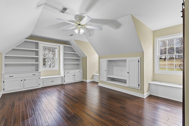 additional living space with built in shelves, ceiling fan, lofted ceiling, and dark hardwood / wood-style flooring