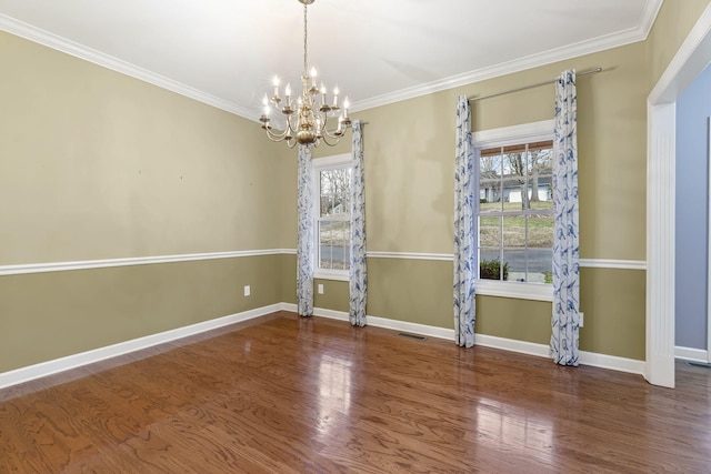 empty room with crown molding, dark wood-type flooring, and a wealth of natural light