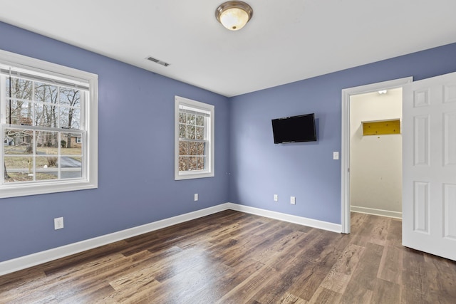 unfurnished room with dark hardwood / wood-style floors