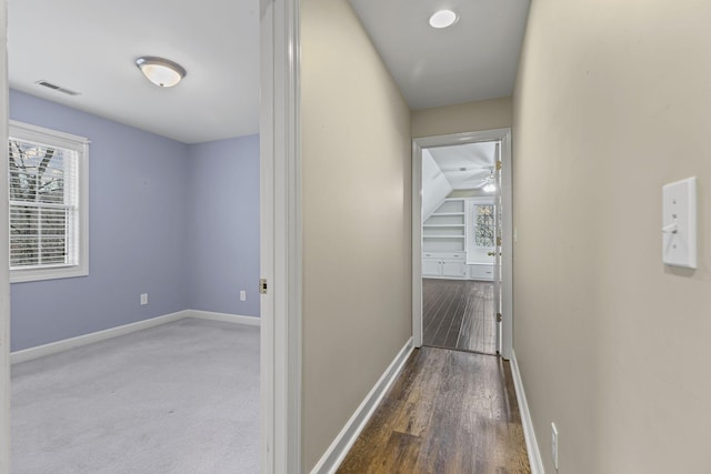 corridor featuring dark wood-type flooring