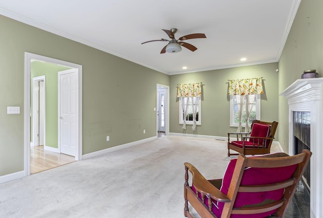 sitting room featuring crown molding, ceiling fan, and carpet