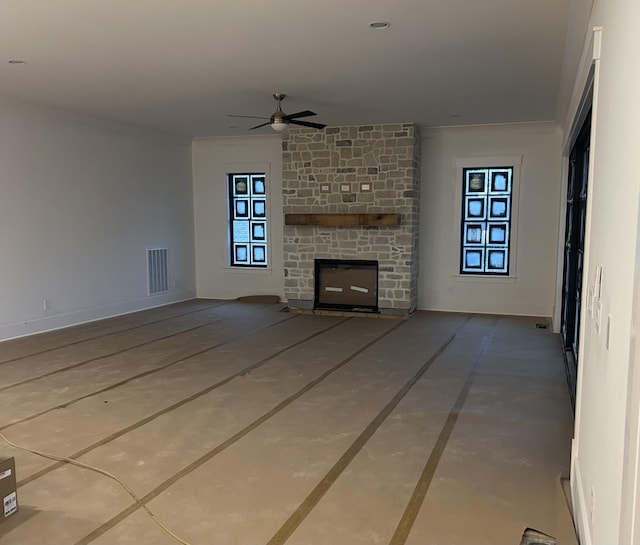 unfurnished living room with crown molding, a fireplace, and ceiling fan