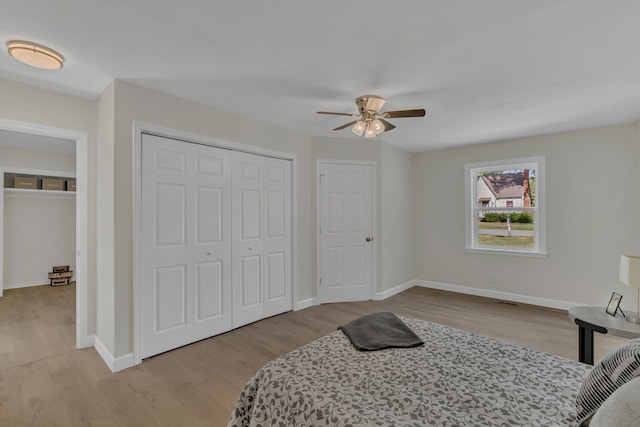 bedroom with ceiling fan and light hardwood / wood-style floors