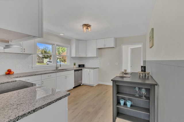 kitchen with dishwasher, white cabinetry, and sink