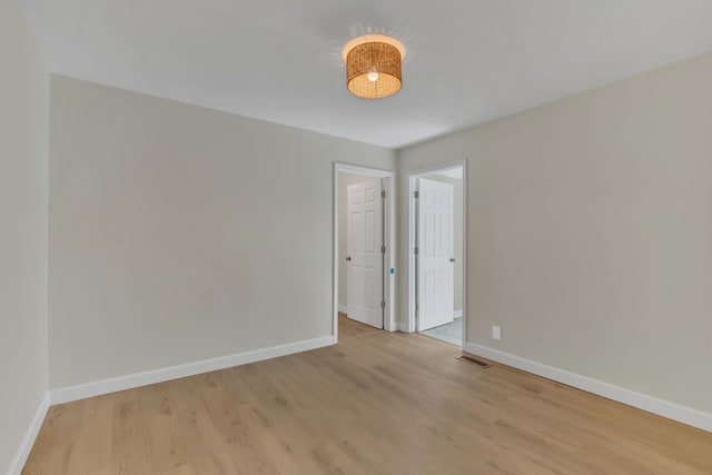 unfurnished room with light hardwood / wood-style flooring