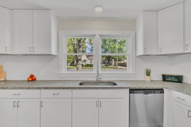 kitchen featuring light stone countertops, dishwasher, sink, decorative backsplash, and white cabinets