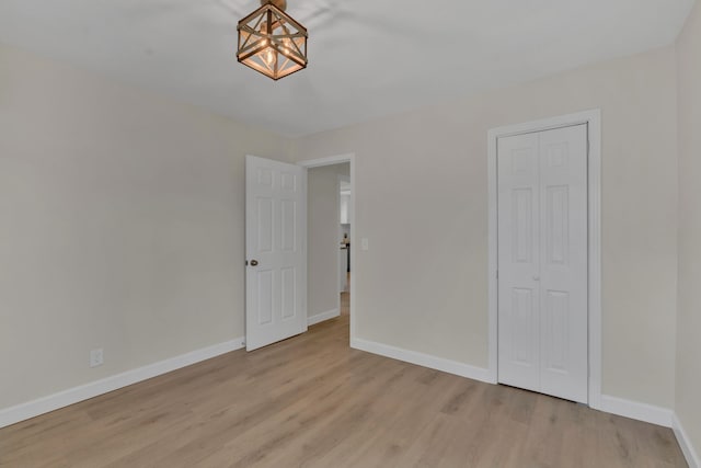 unfurnished bedroom featuring a closet and light hardwood / wood-style floors