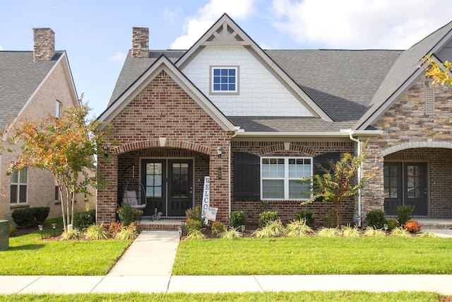 view of front of house with a front yard and french doors