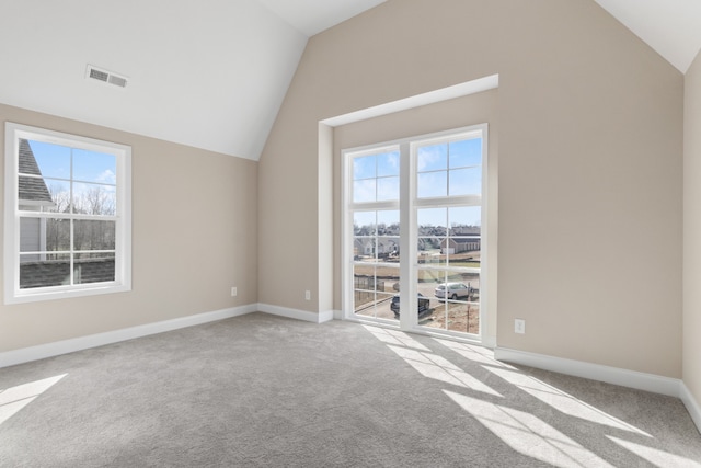 bonus room with lofted ceiling and light carpet