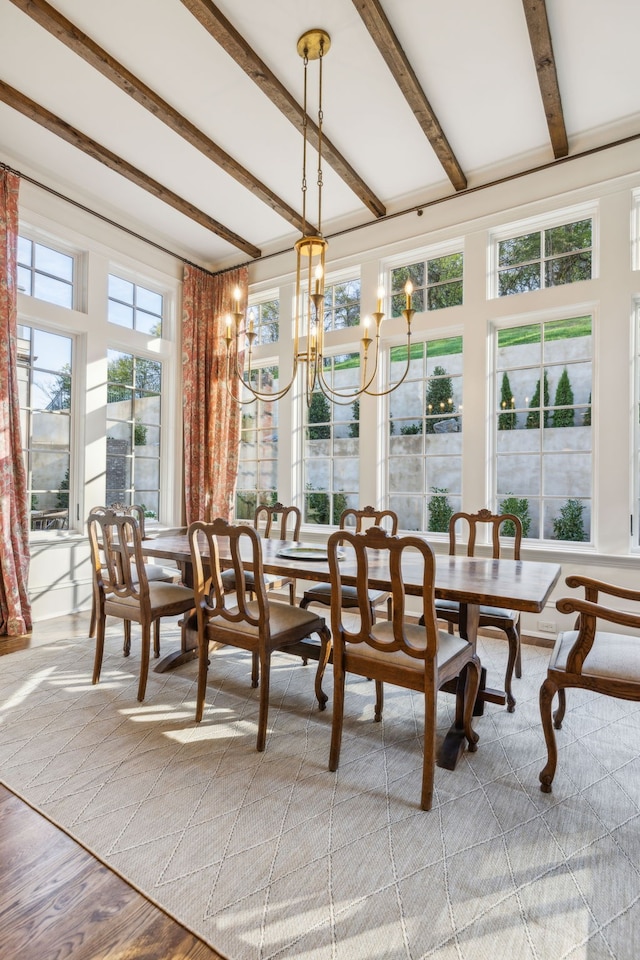 sunroom with beamed ceiling and an inviting chandelier