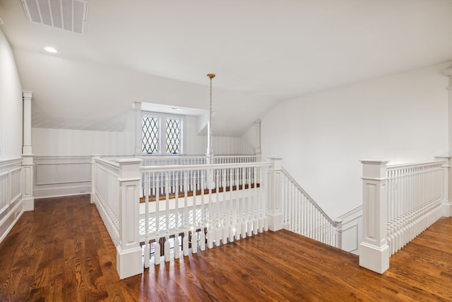 staircase featuring hardwood / wood-style flooring and vaulted ceiling