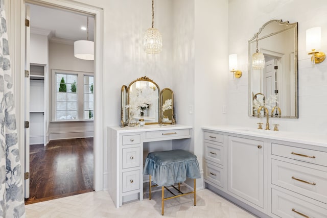 bathroom with vanity, ornamental molding, and hardwood / wood-style flooring