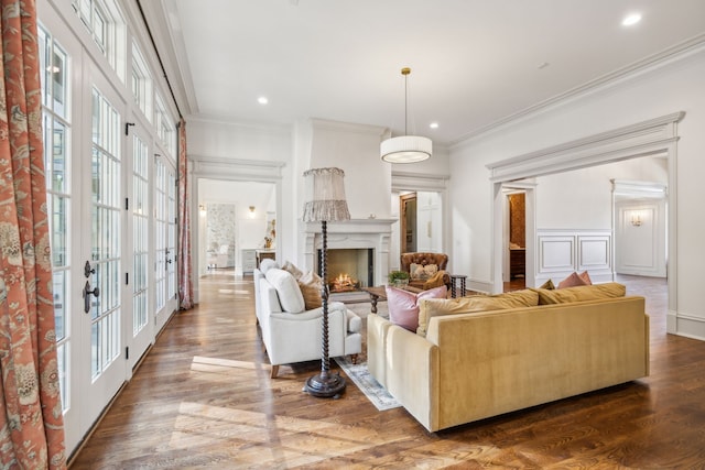 living room with french doors, wood-type flooring, and ornamental molding