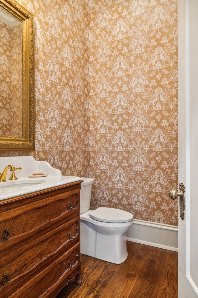 bathroom featuring hardwood / wood-style floors, vanity, and toilet