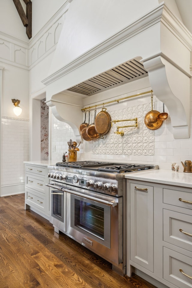 kitchen with decorative backsplash, dark hardwood / wood-style flooring, gray cabinets, and double oven range