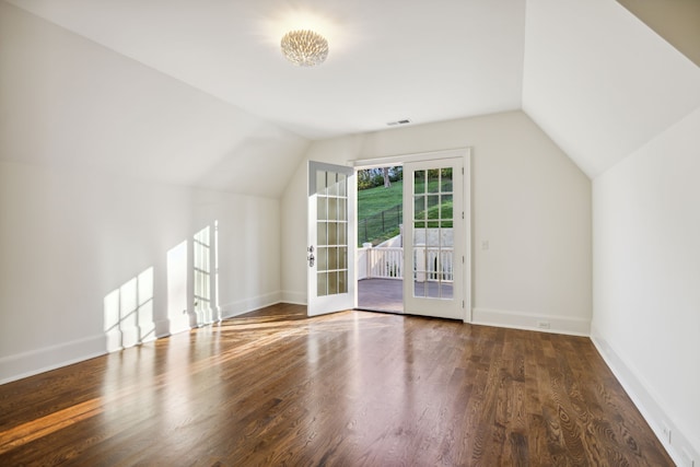 additional living space featuring french doors, wood-type flooring, and lofted ceiling