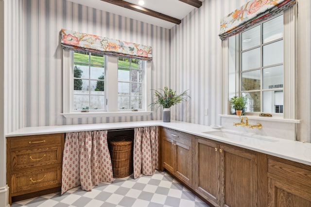 bathroom with beam ceiling and vanity