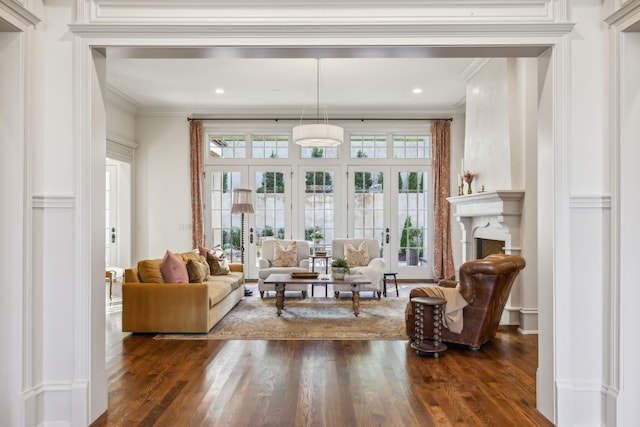 living room with french doors, ornamental molding, and dark wood-type flooring