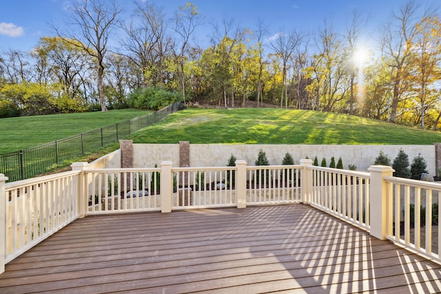 wooden deck featuring a lawn