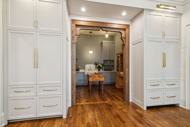 corridor with dark hardwood / wood-style flooring