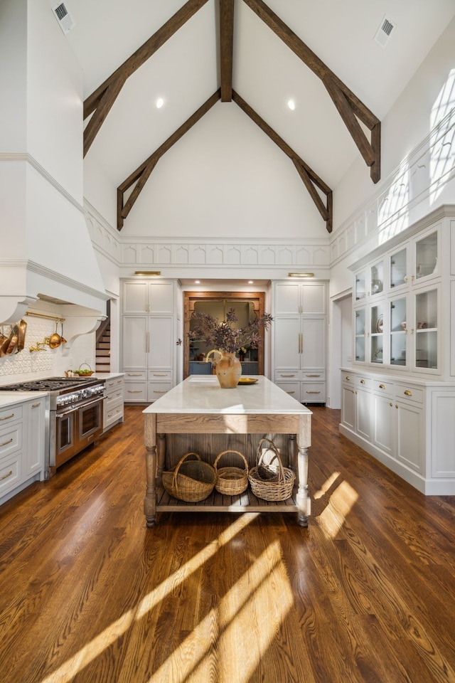 living room with beamed ceiling, high vaulted ceiling, and dark wood-type flooring